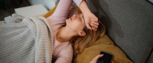 Frau mit Handy im Bett